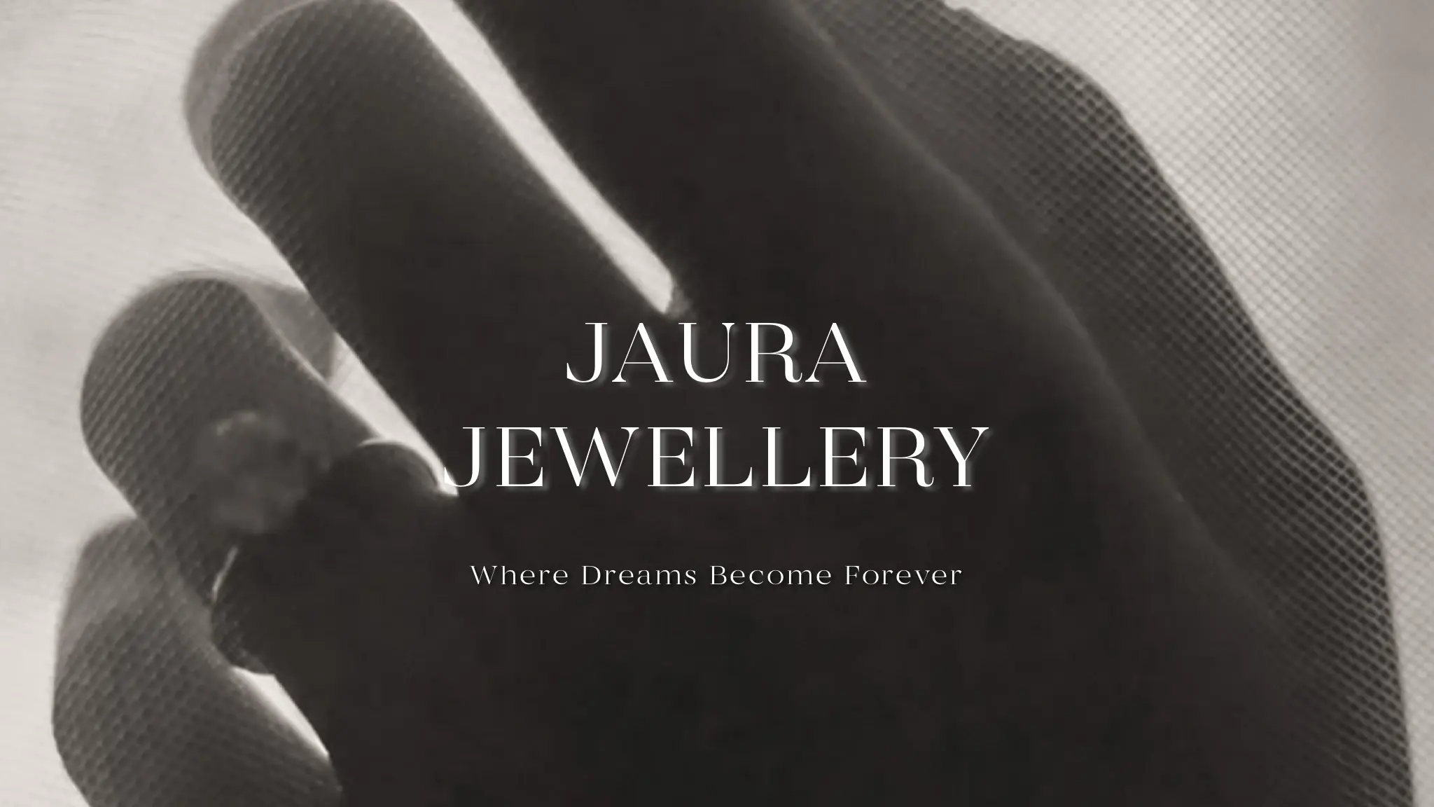 Jaura Jewellery — Where Dreams Become Forever. A hand wearing a diamond ring behind sheer fabric